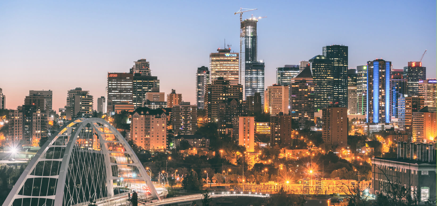 a view of a city at night from a bridge